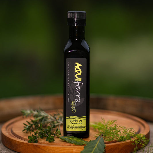 Aquiferra Herbes de Provence olive oil bottle, infused with rosemary, thyme, dill, and bay, ideal for marinating meats, roasting vegetables, and enhancing potatoes.